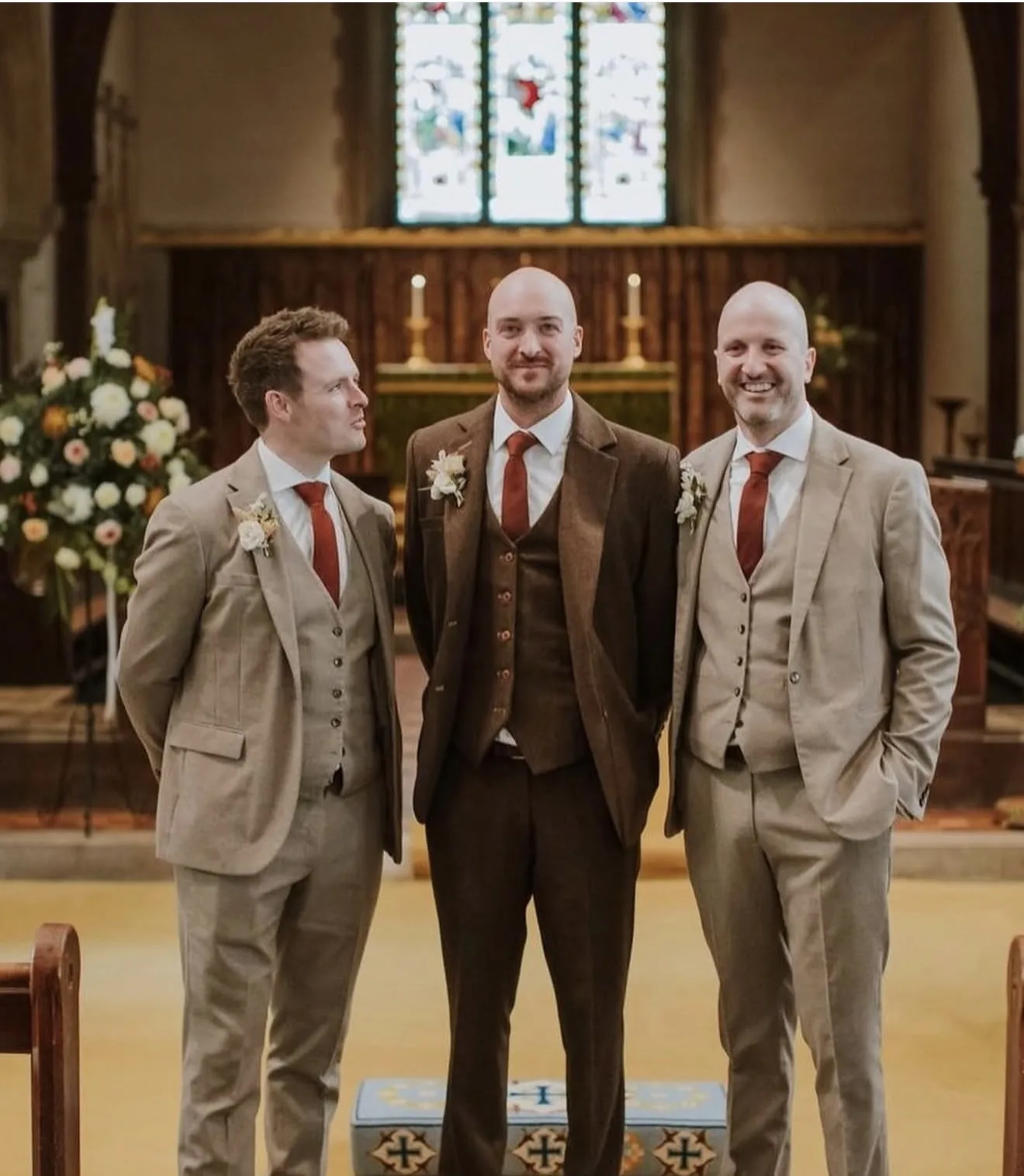 Groom and groomsmen in tweed wedding suits at a church