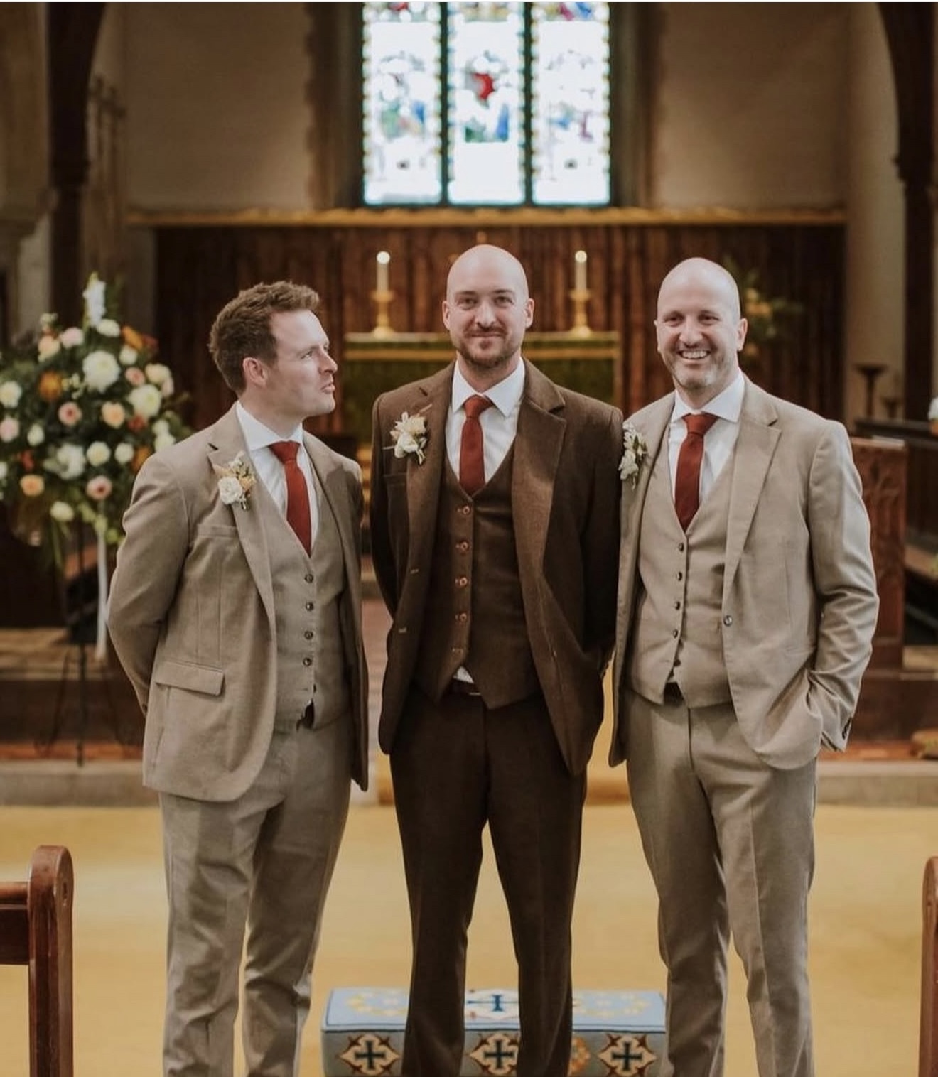 Groom and groomsmen in tweed wedding suits at a church